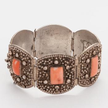A silver bracelet with corals.