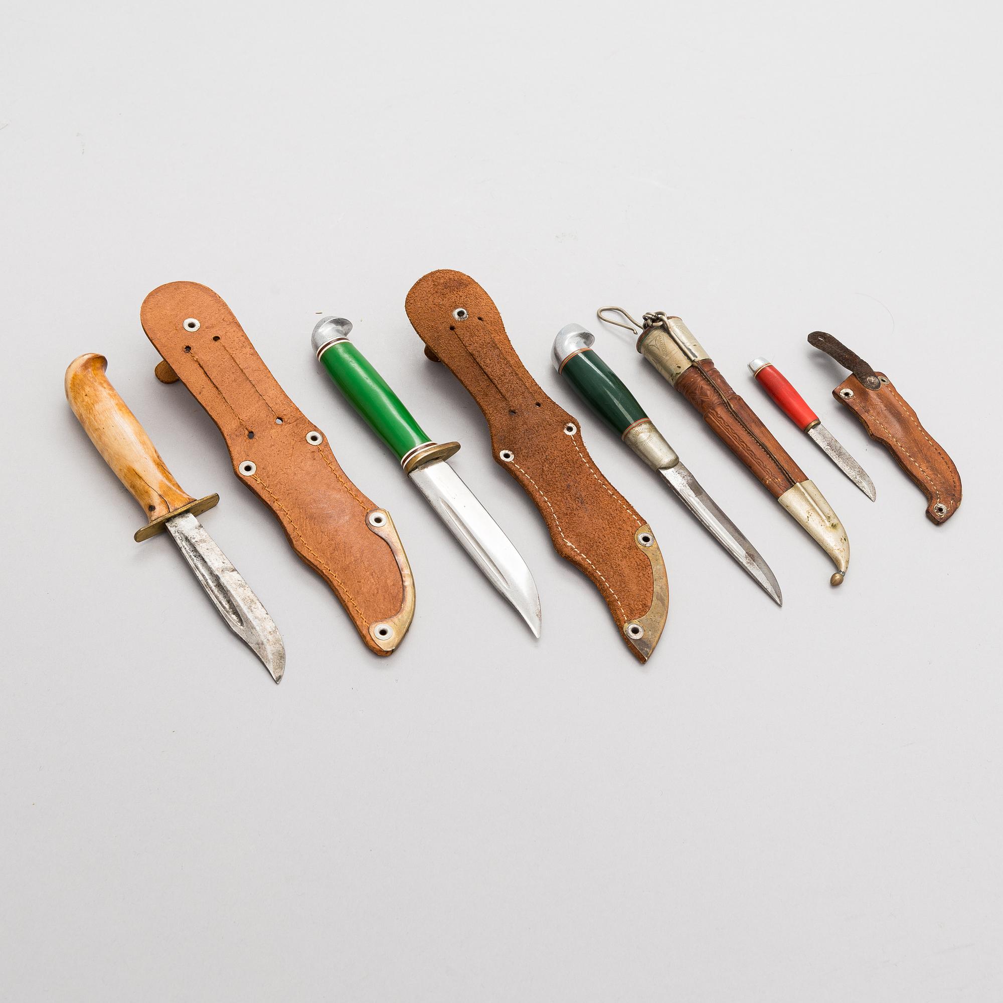 A set of four puukko knives and leather sheats, marked Olympia Helsinki -52.