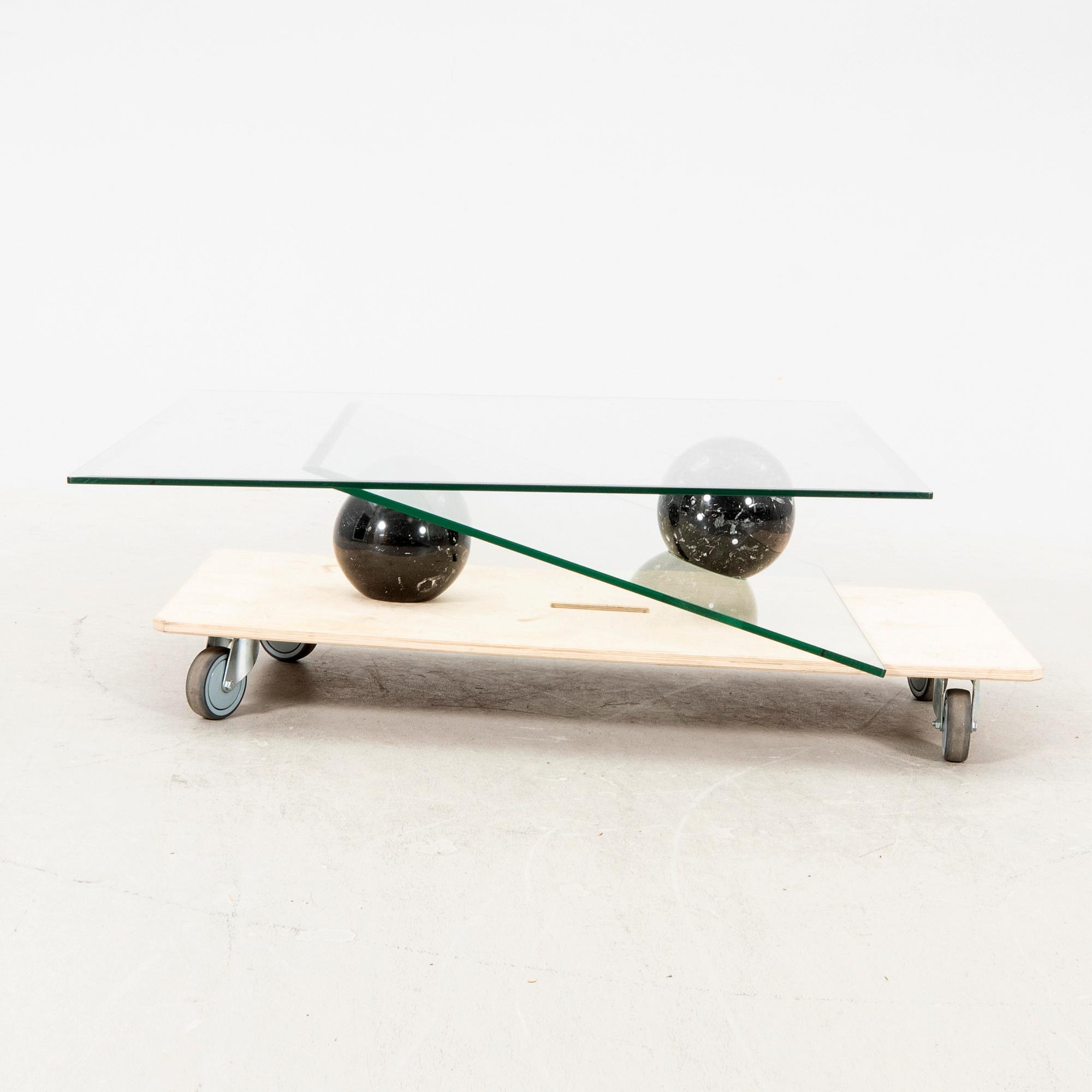 A Roche Bobois glass and marble coffee table alter part of the 20th century.