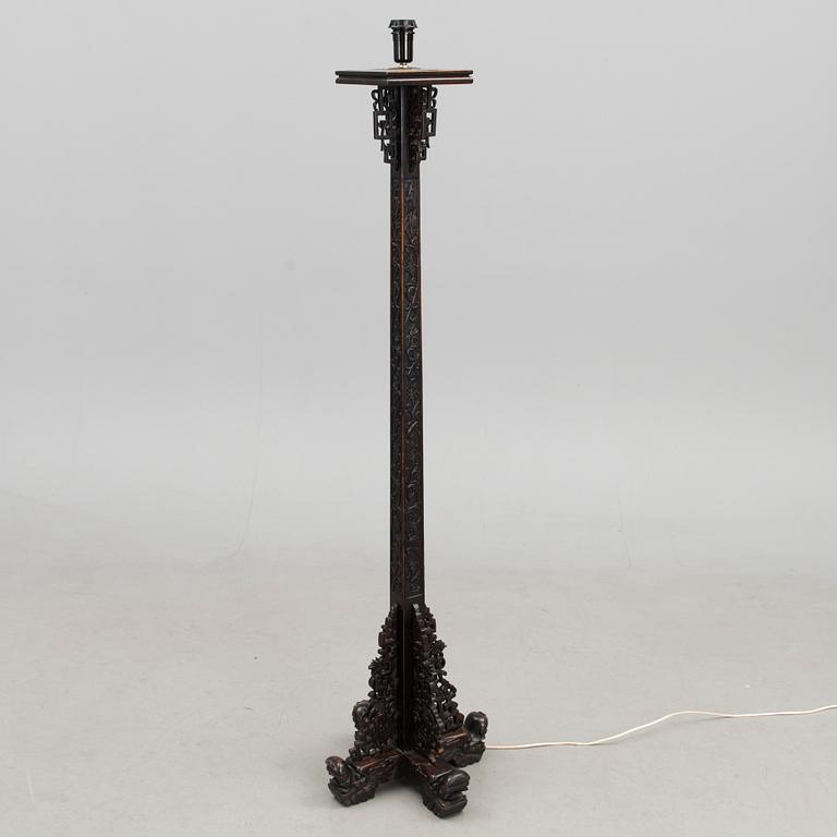 A Chinese carved wood floor lamp from the first half of the 20th Century.