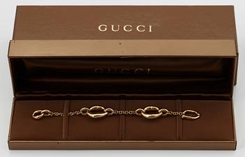 An 18K gold Gucci bracelet.