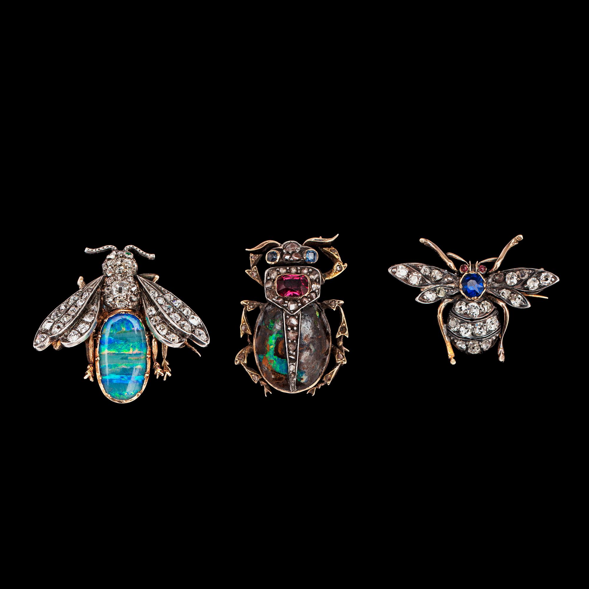 A box of three diamond flies and bug brooches.