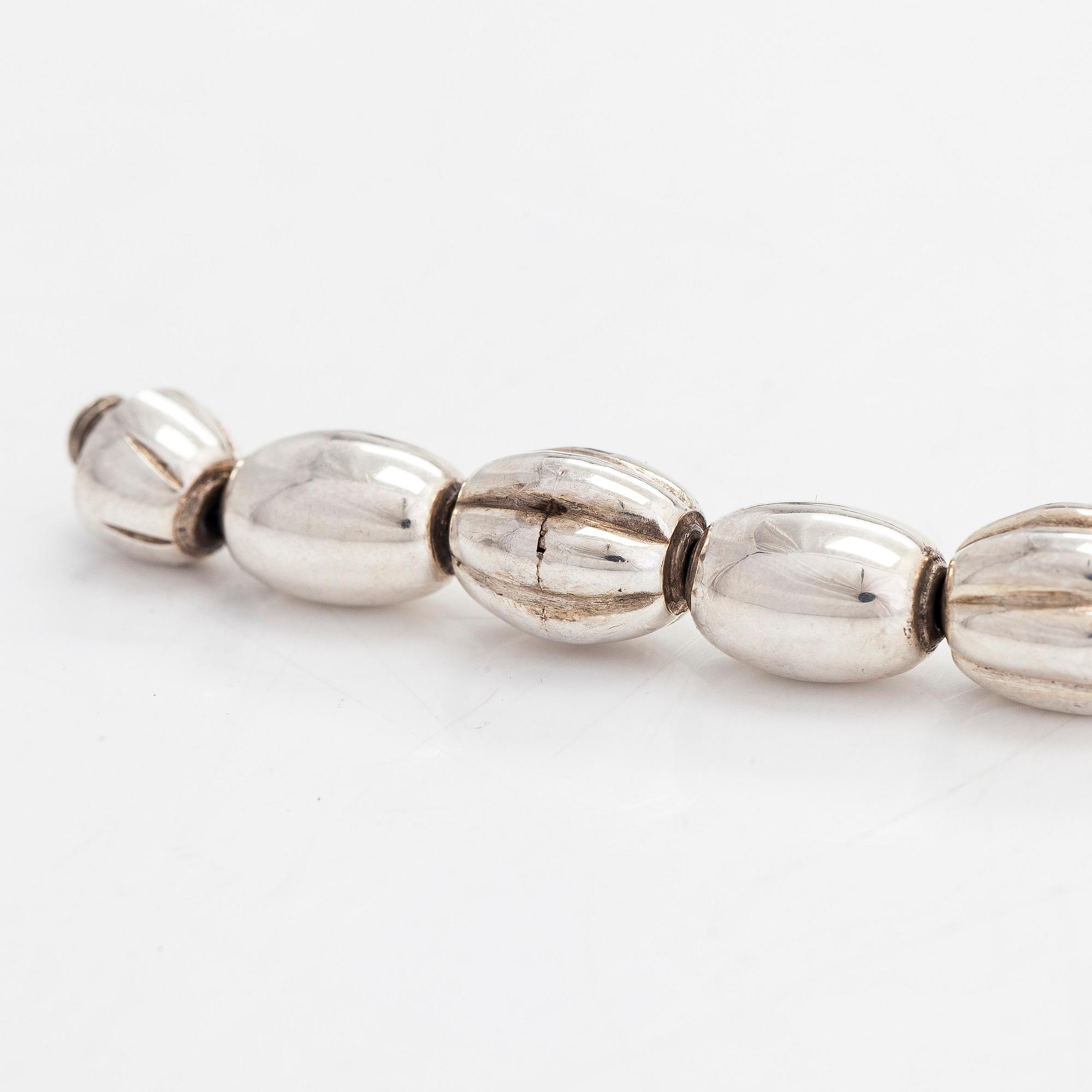 A set of silver "Halikko treasure" necklace, bracelet, ring and earrings. Kalevala Koru, Helsinki 1965-1972.