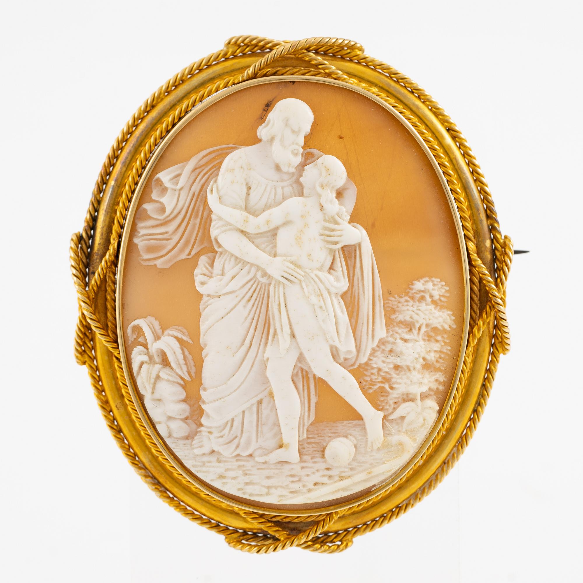 A brooch with a large shell cameo.
