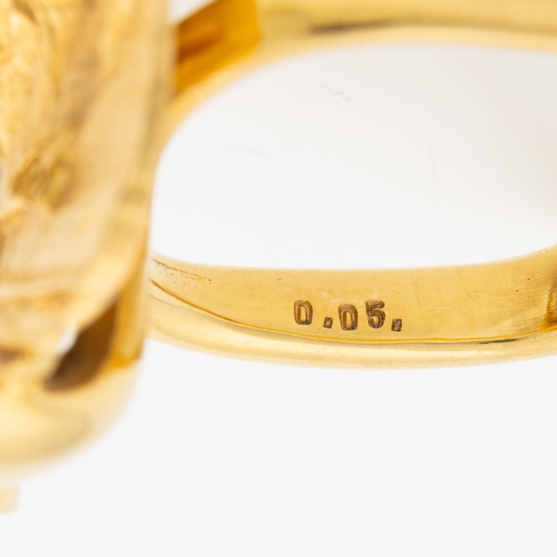 A ring, 18K gold with a fancy-cut smoky quartz and round brilliant-cut diamonds.