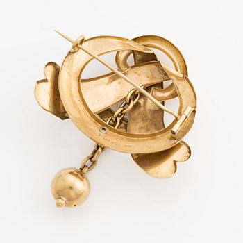 Brosch, 18K guld med kläpp i form av kula.