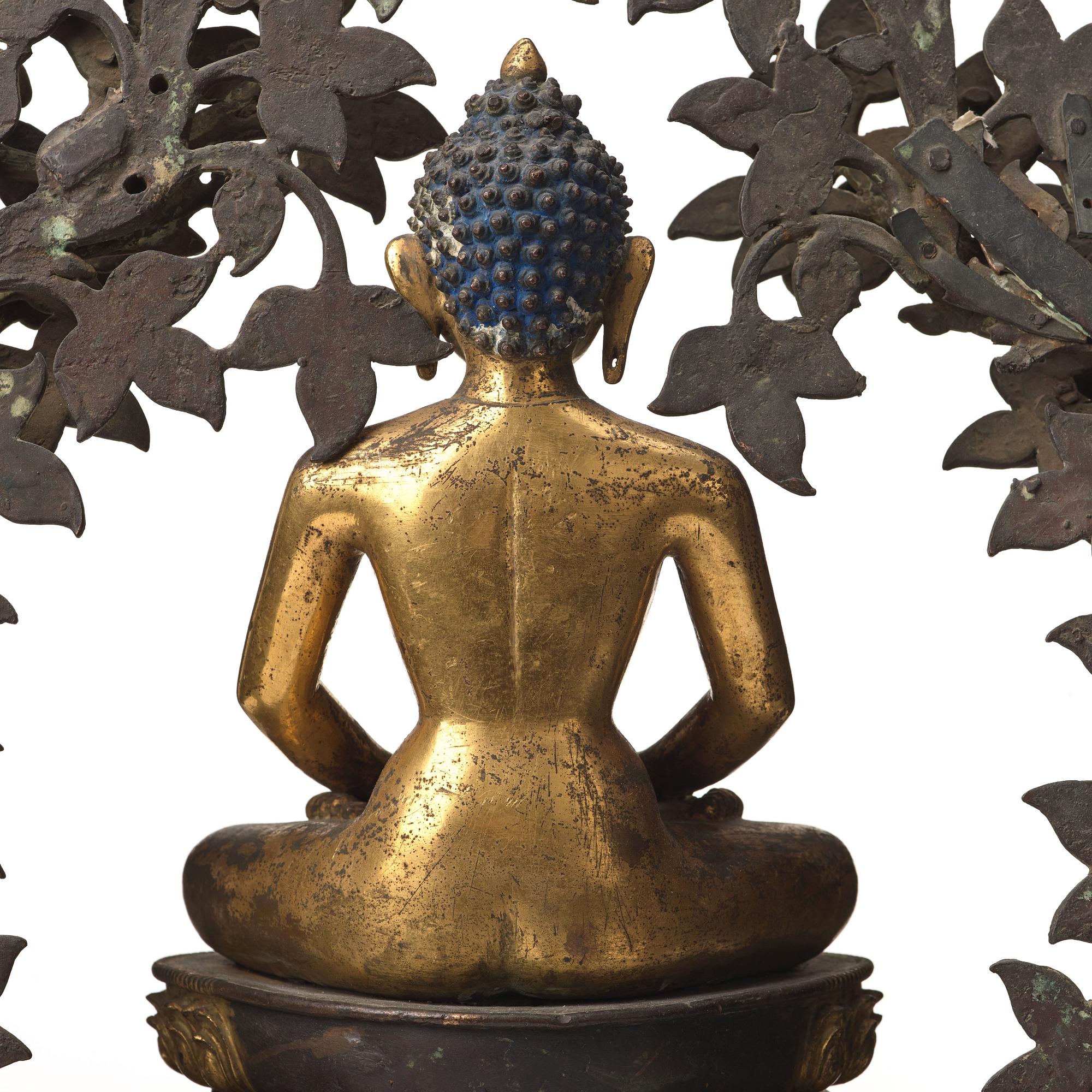 A large Nepalese gilt bronze buddha on a throne with mandorla, 18/19th Century.