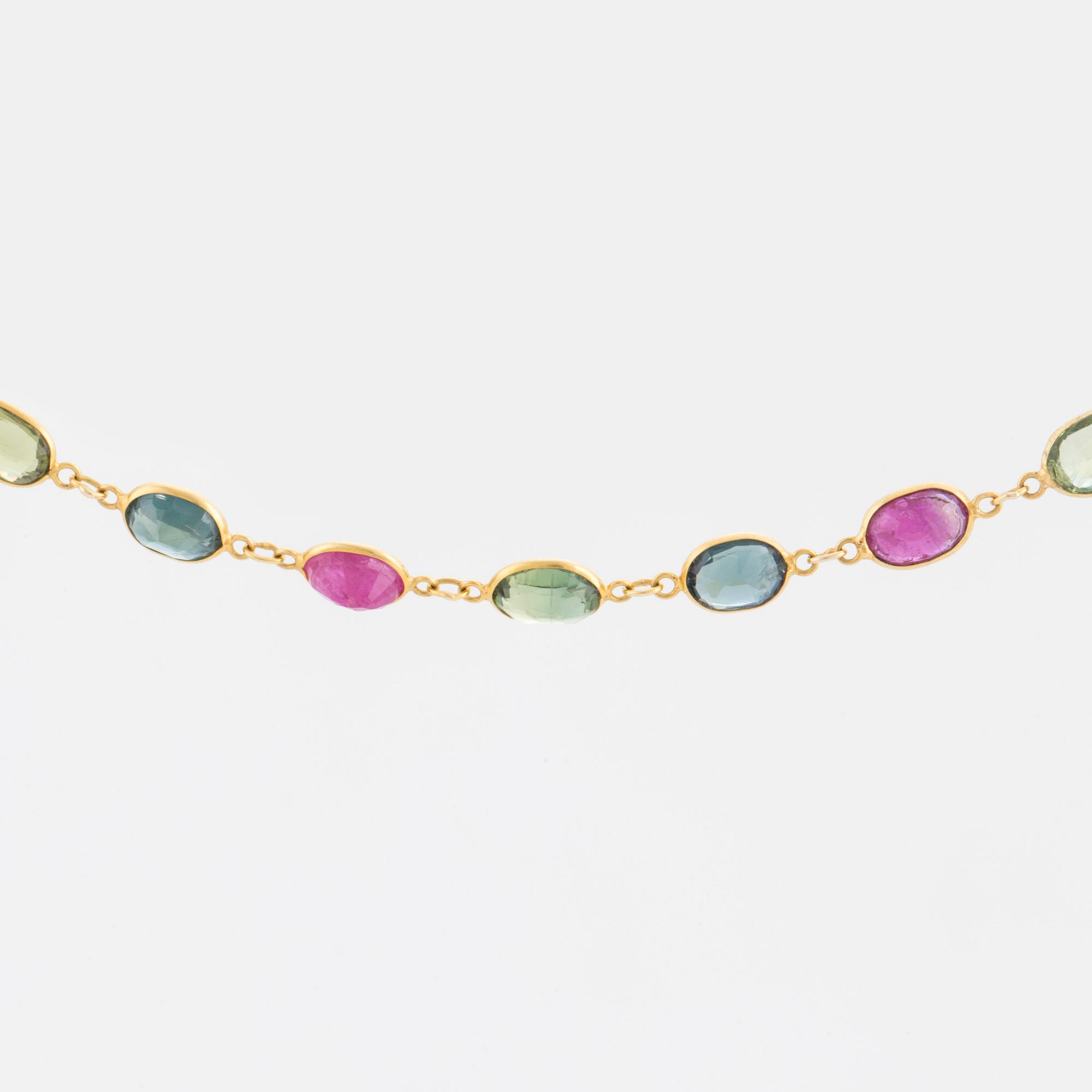 A necklace set with oval, mixed-cut, multi-coloured gemstones.