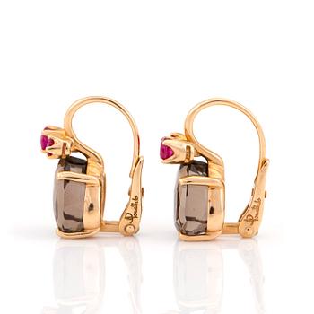 A pair of 'Bahia' earrings by Pomellato set with mixed-cut smokey quartz and rubies.