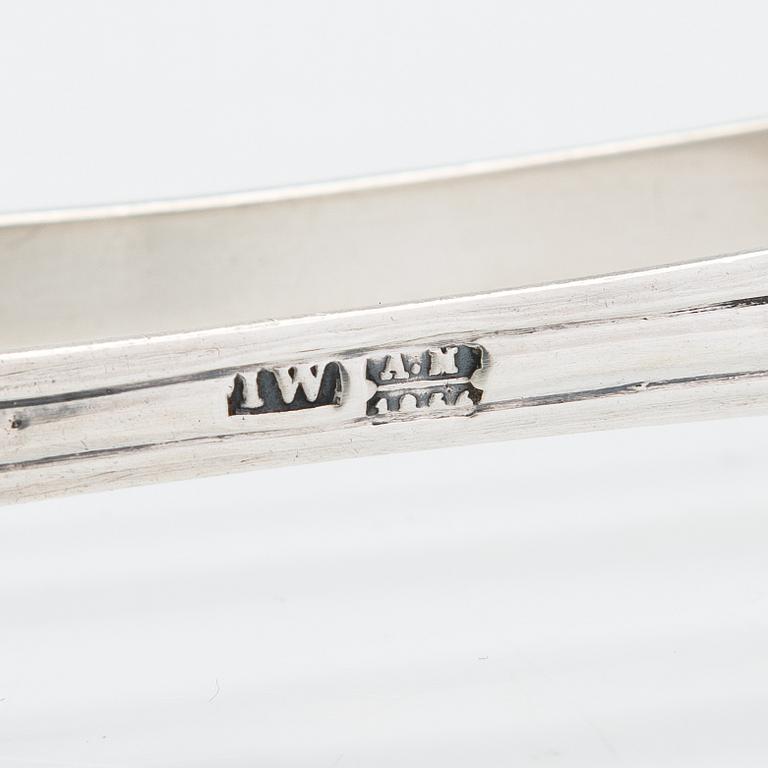 A silver sugar tong by Johan Warjus, and a silver salt cellar by Adolf Sper, St Petersburg 1856 and 1849.