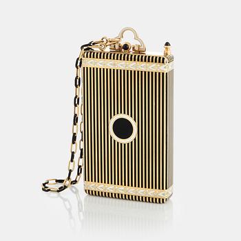 A Cartier Art Deco Vanity Case/Minaudière in 18K gold, black enamel and onyx. on the inside a mirror, a separate compartment with lid, a...