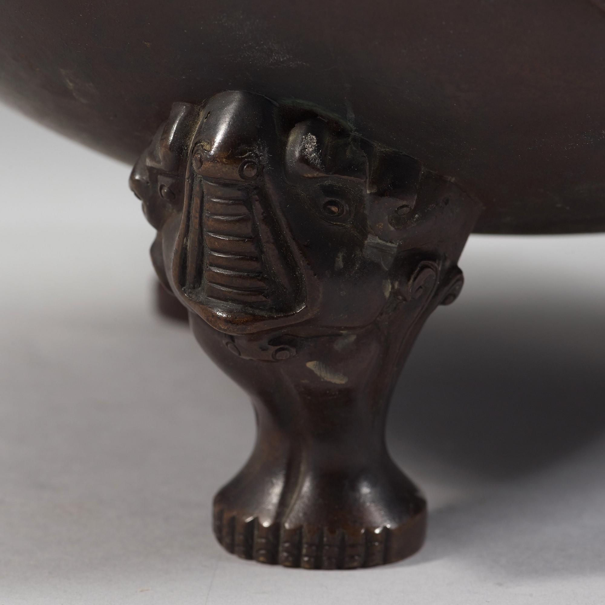 A bronze tripod censer with cover and stand, Qing dynasty, 17/18th Century.