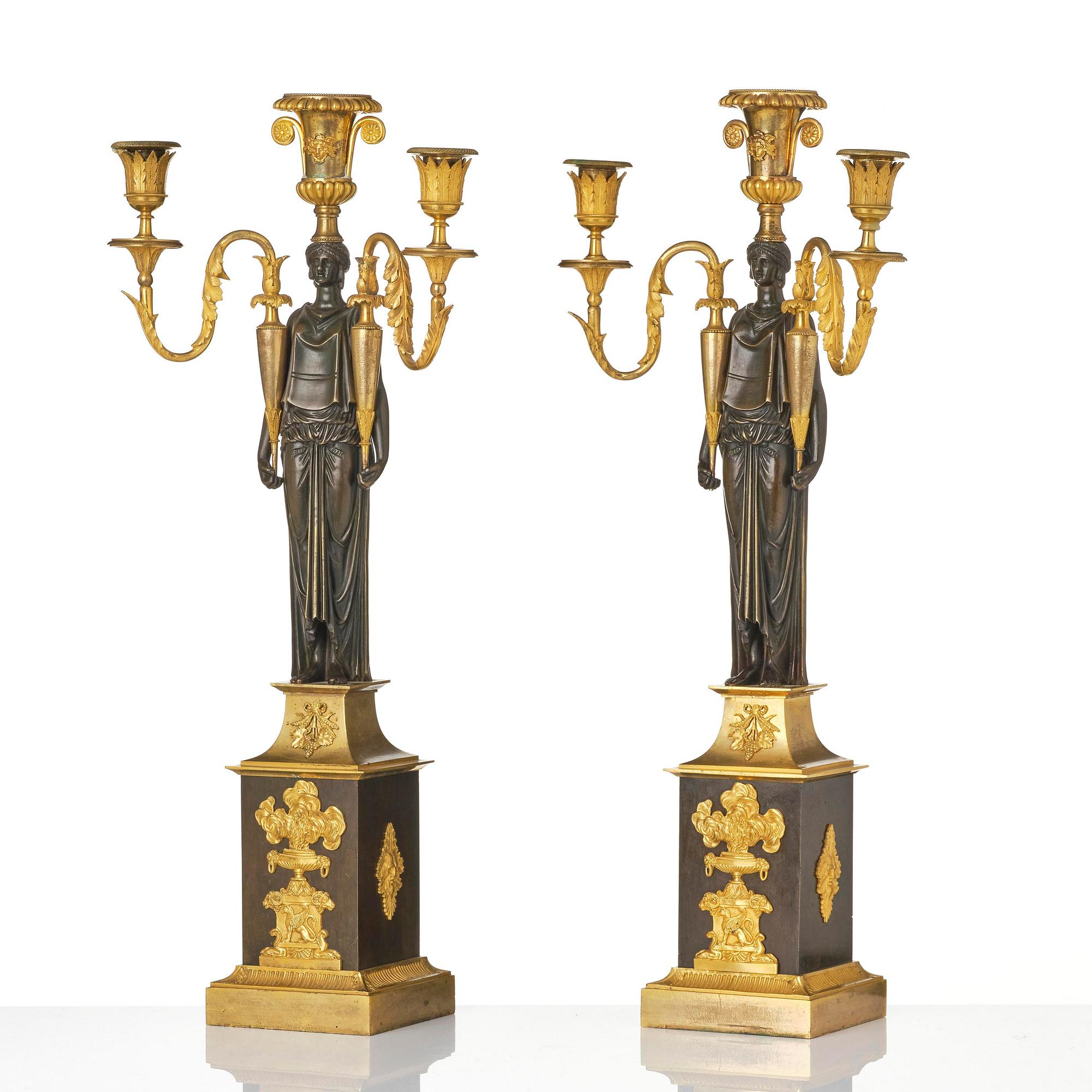 A pair of French Empire ormolu three-branch candelabra, Paris, early 19th century.