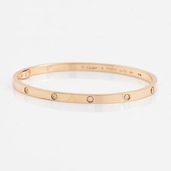 A Cartier "Love" bracelet small model in 18K rose gold with ten round brilliant-cut diamonds.