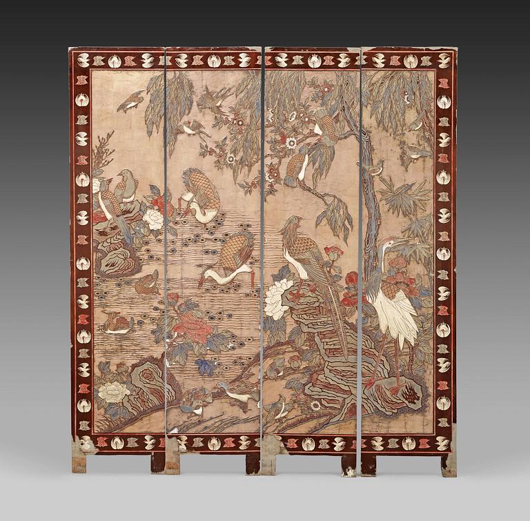 A coromandel black-lacquer four panel screen, Qing Dynasty (1644-1912).