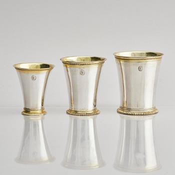 Three Swedish 18th century parcel-gilt silver beakers and a case of birch, different maker's.