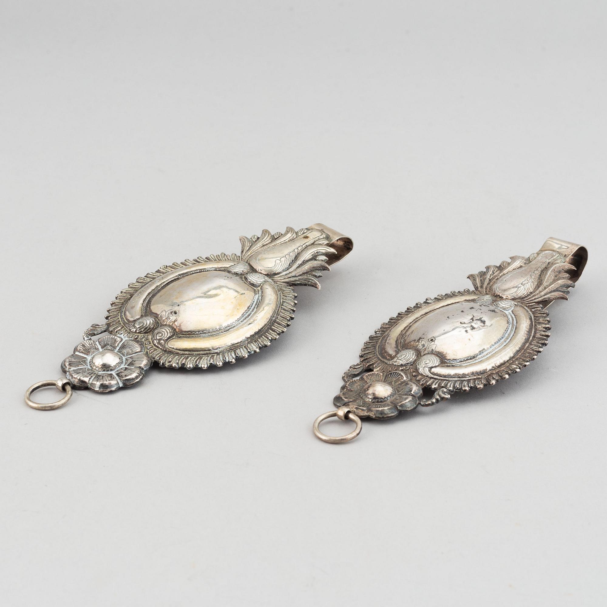 A pair of 19th century silver curtain tie-backs.