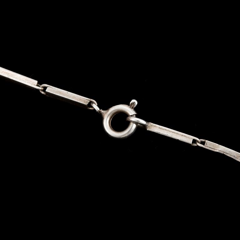 A glass pendant designed by Gunnar Cyrén and a silver necklace.