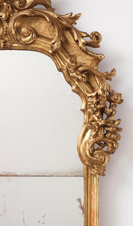 A presumably German giltwood rococo mirror, mid 18th century.