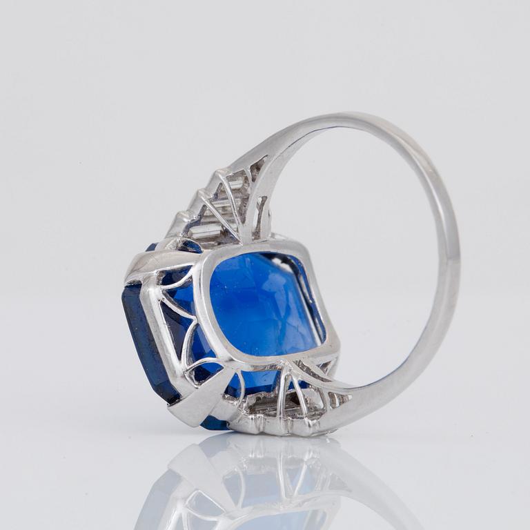 An unheated 11.27 ct Ceylon sapphire and baguette-cut diamond ring. Total carat weight of diamonds 0.70 cts.