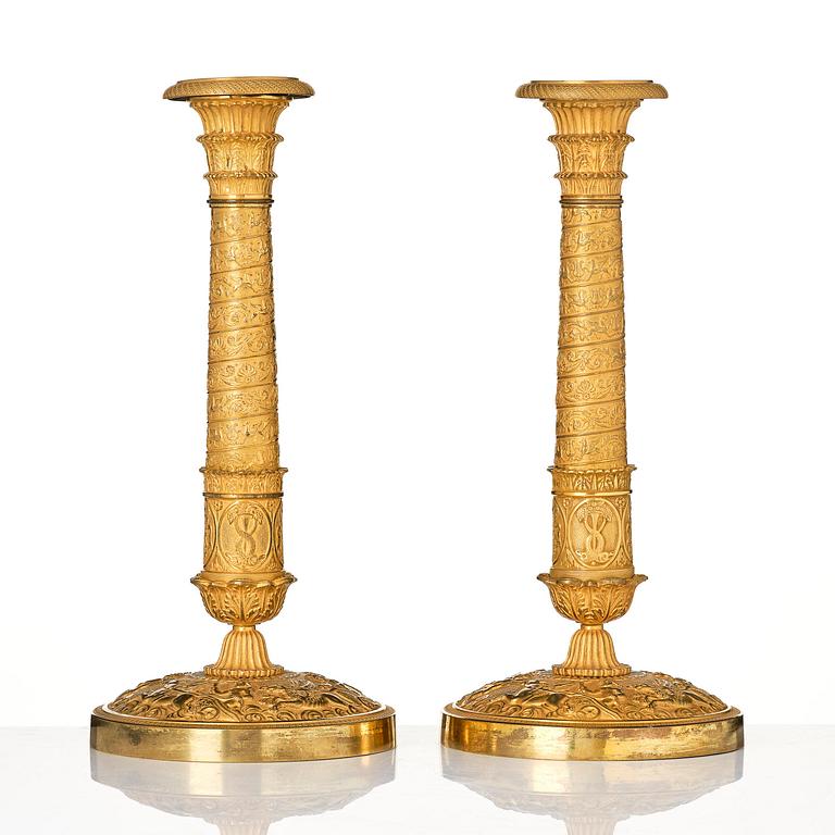 A pair of French Empire ormolu candlesticks, Paris, early 19th century.