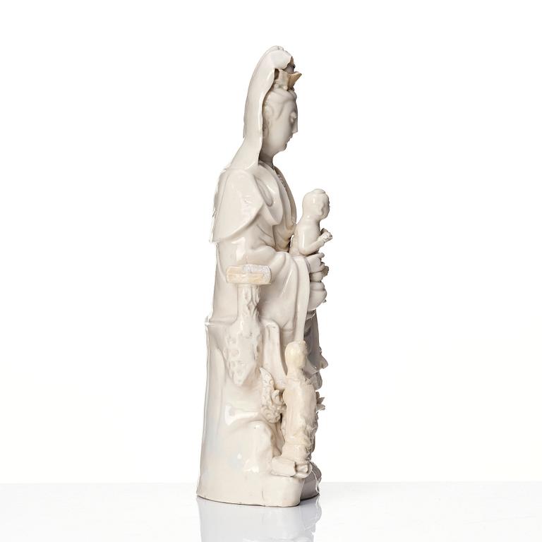 A Chinese blanc de chine Guanyin with attendants, Dehua, late Ming dynasty/early Qing dynasty.