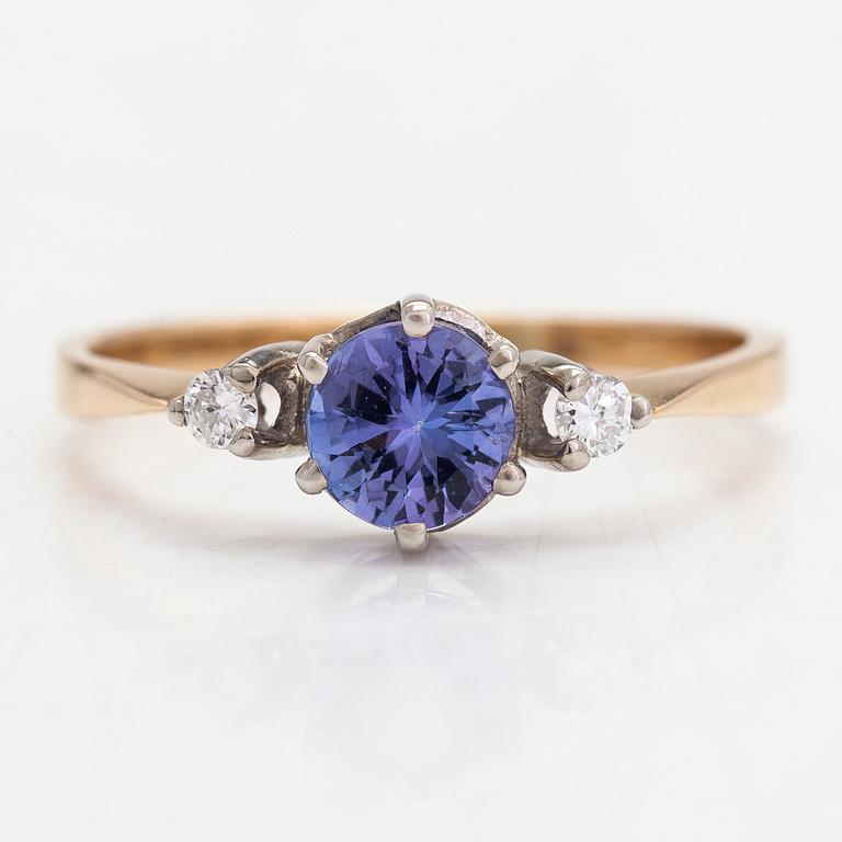 An 18K white gold ring, with a tanzanite and diamonds totalling approximately 0.04 ct.