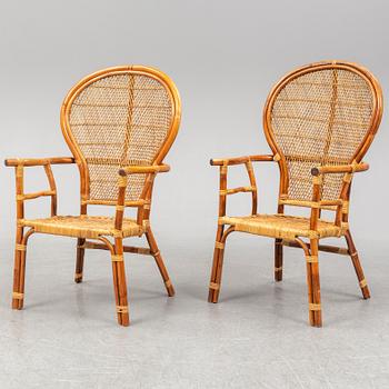 A pair of rattan chairs.