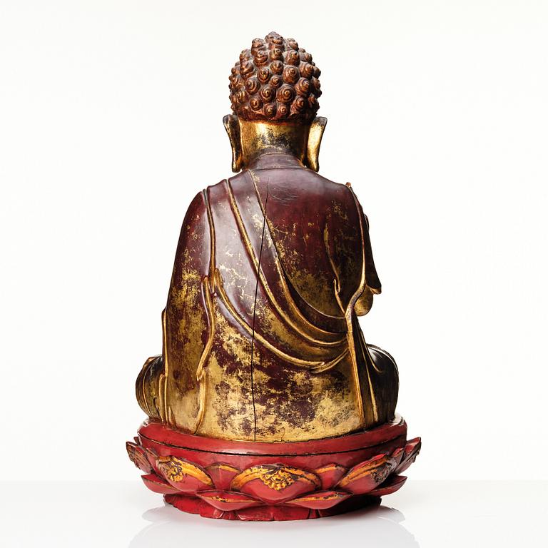 A large gilt and lacquered figure of a seated buddha, Qing dynasty, 19th Century.