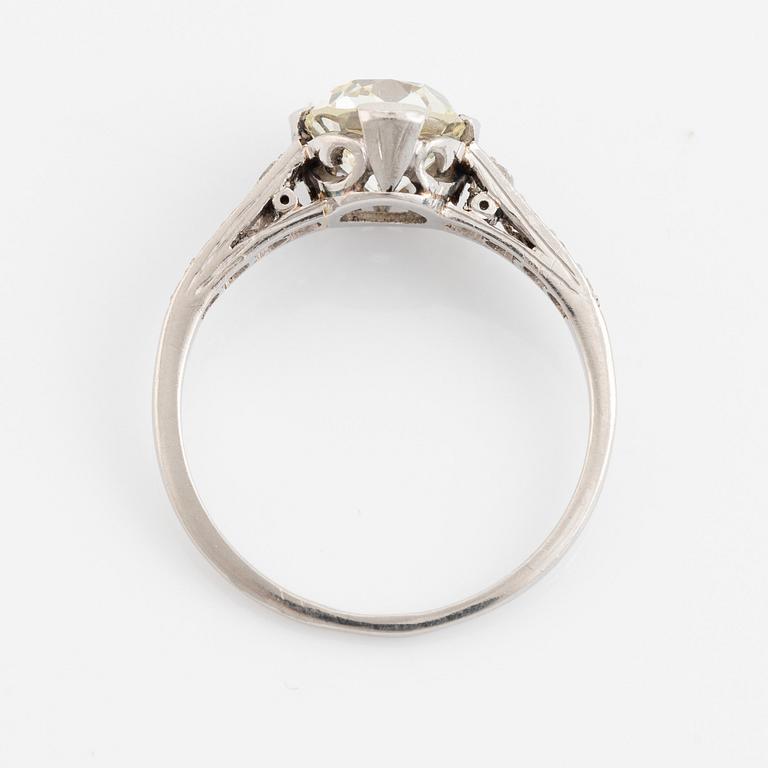 A platinum ring set with a cushion-formed old-cut diamond.