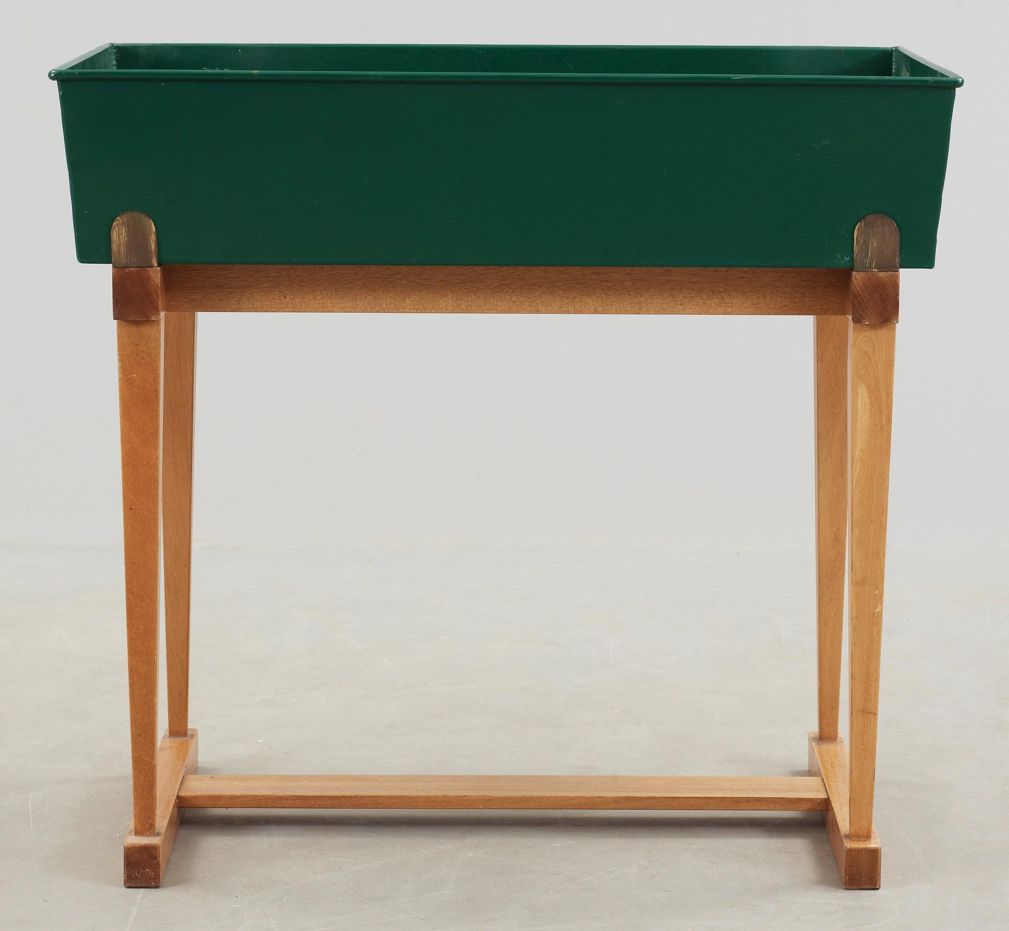 A Josef Frank green lacquered jardiniere on a walnut stand, Svenskt Tenn, Sweden 1960's.