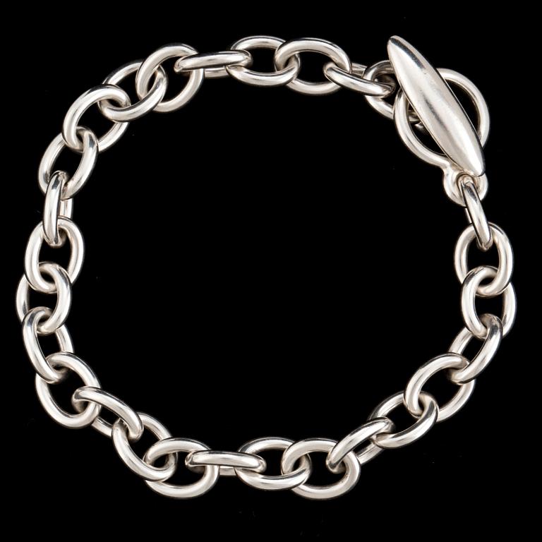 A silver bracelet and three charms by Georg Jensen, after 1945.