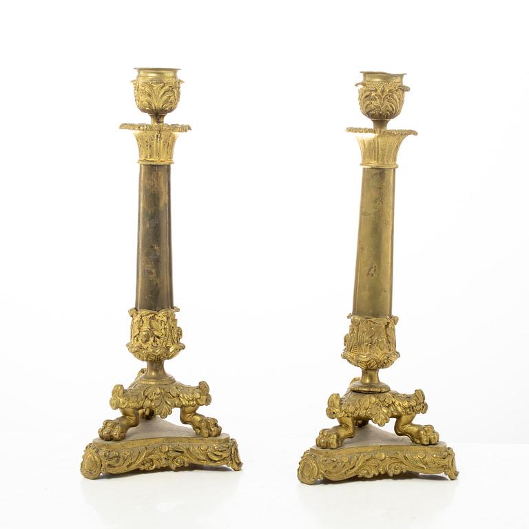 A pair of brass and bronze late Empire candle sticks, mid 20th century.