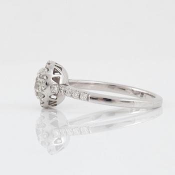 A brilliant-cut diamond ring. Center stone 1.03 cts F/VS1, surrounded by 0.36 ct pavé-set diamonds.