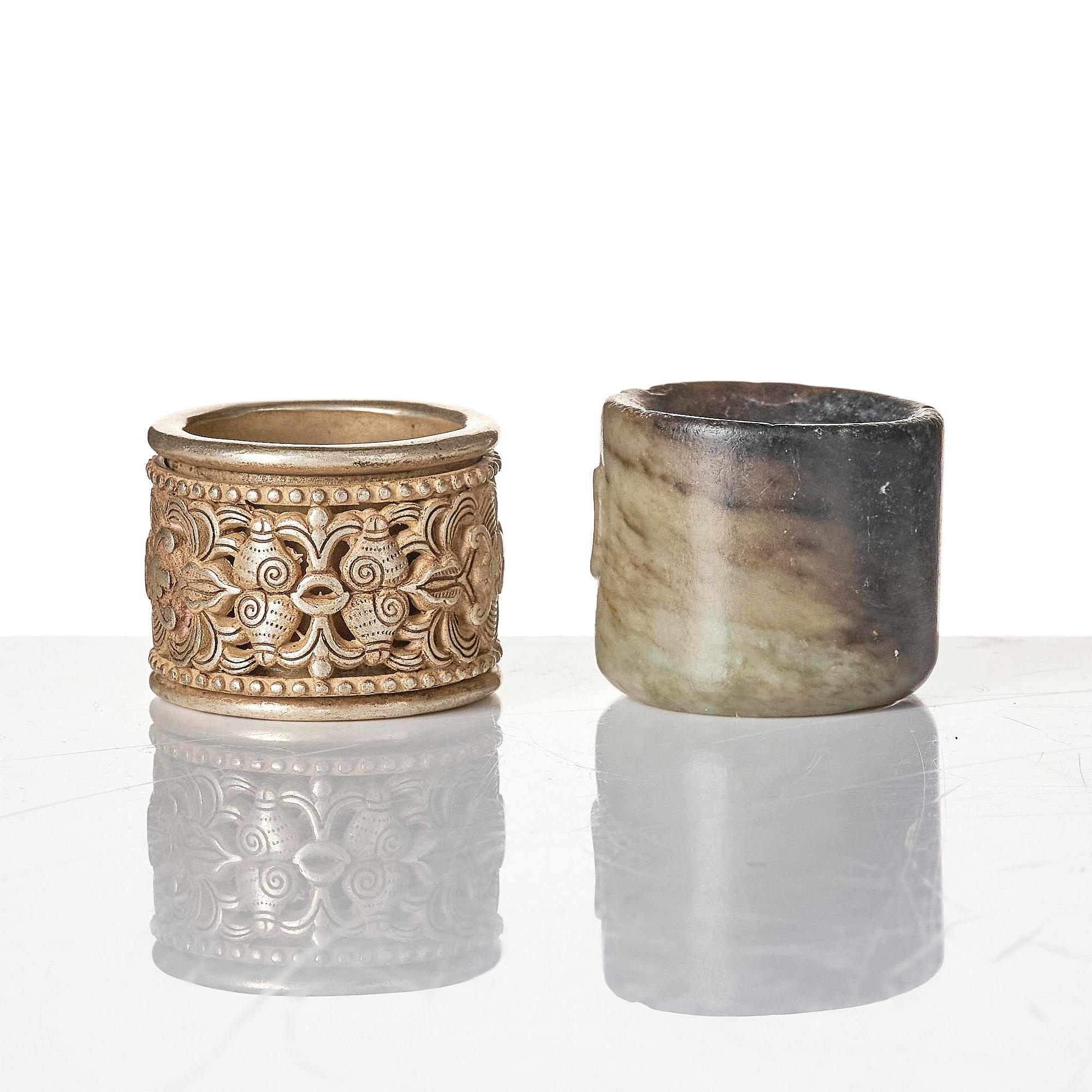 Two archers rings and two nephrite carvings.