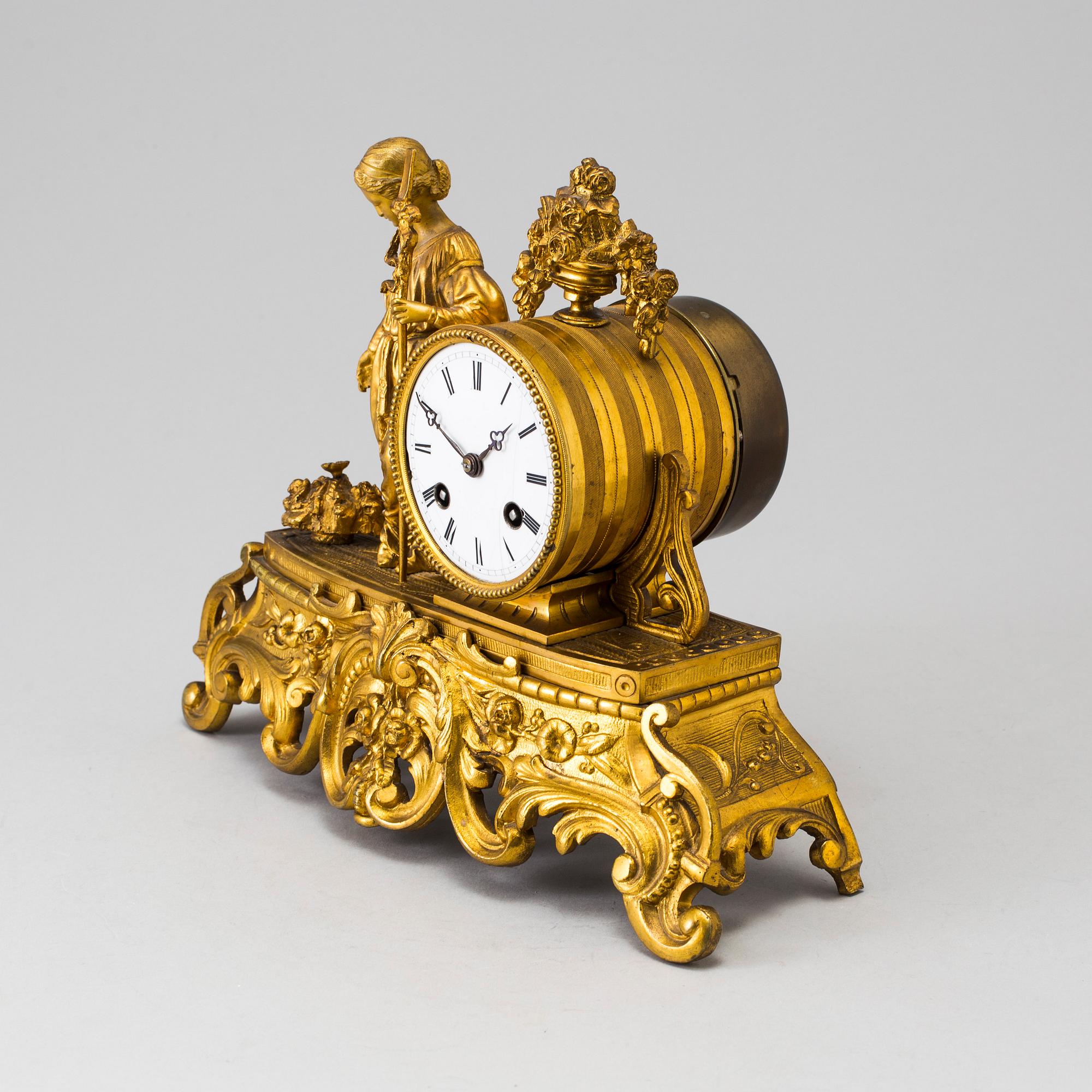A LATE 19TH CENTURY GILT METAL MANTLE CLOCK in the Rococo style.
