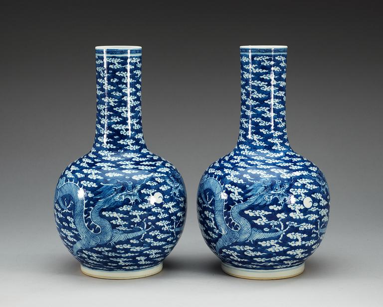 A pair of blue and white vases, late Qing dynasty, with Kangxi four character mark.