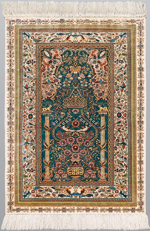 A pictorial oriental silk rug, ca 121 x 77 cm.