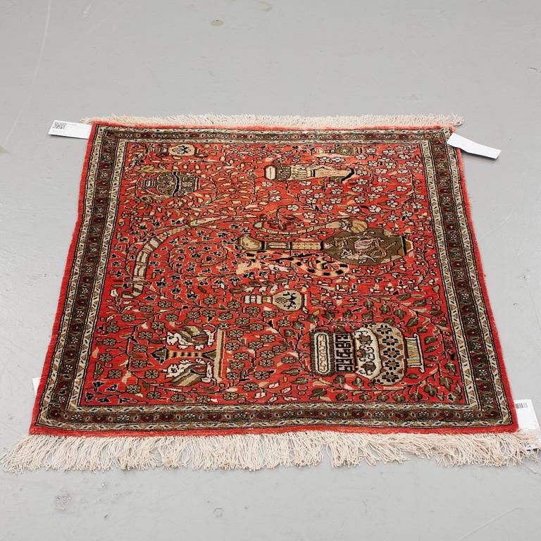 A RUG, AN OLD SILK QUM, ca 75 x 65 cm.