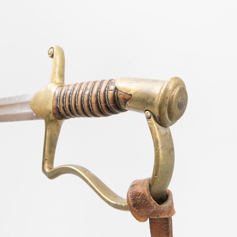 A Swedish sabre 1899 pattern with scabbard with another sword.