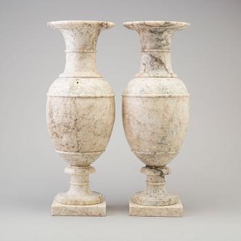 A pair of marble urns, circa 1900.