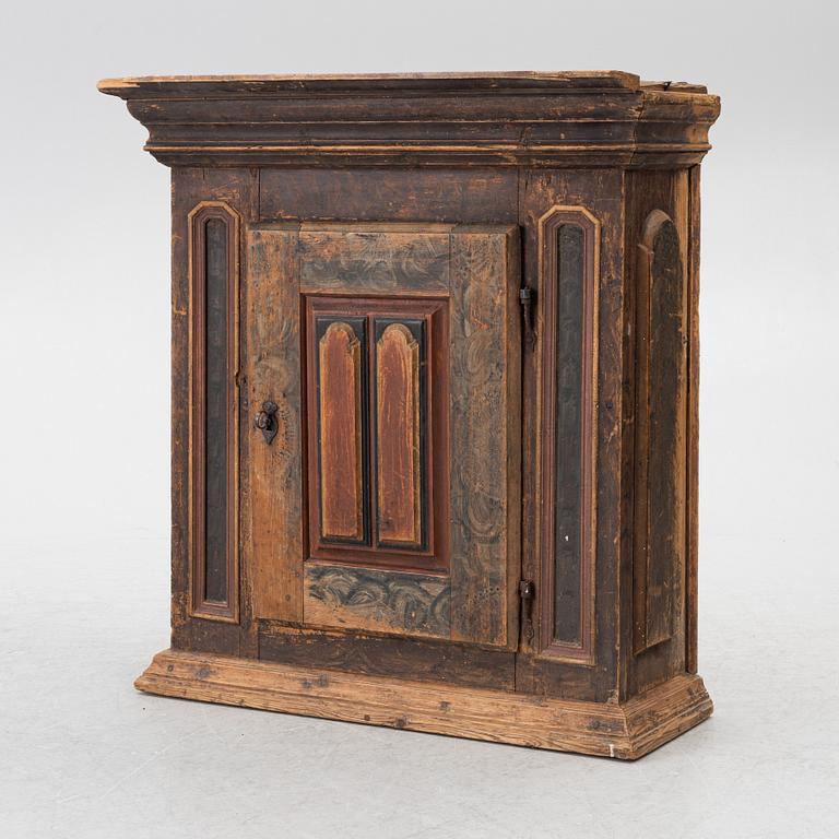 A polychrome-painted folk art hanging cabinet from Järvsö, Sweden, early 19th century.