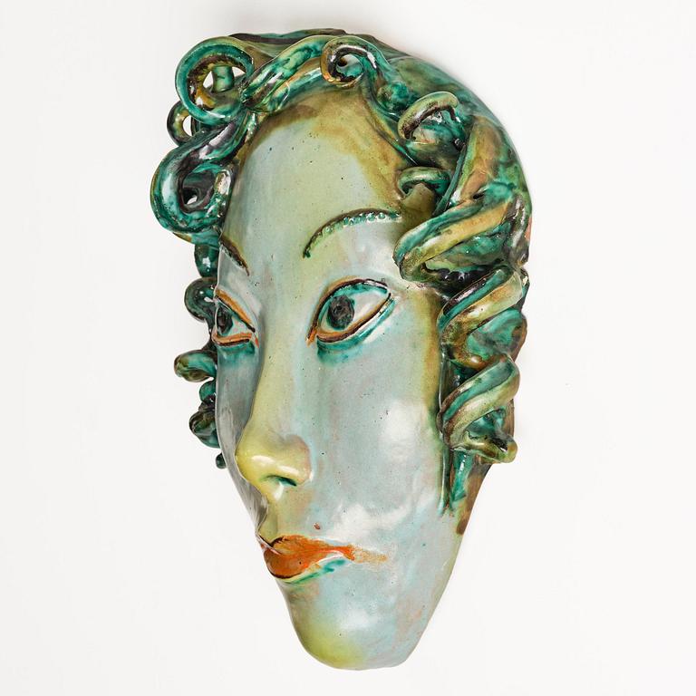 Allan Ebeling, a glazed earthenware wall sculpture of a masque, Torshälla 1934.