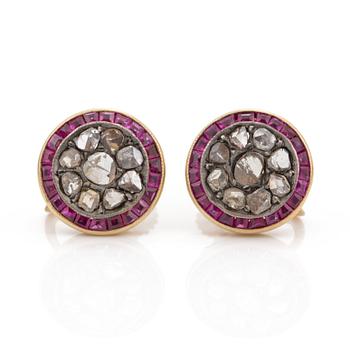 A pair of step cut ruby and rose cut diamond earrings.