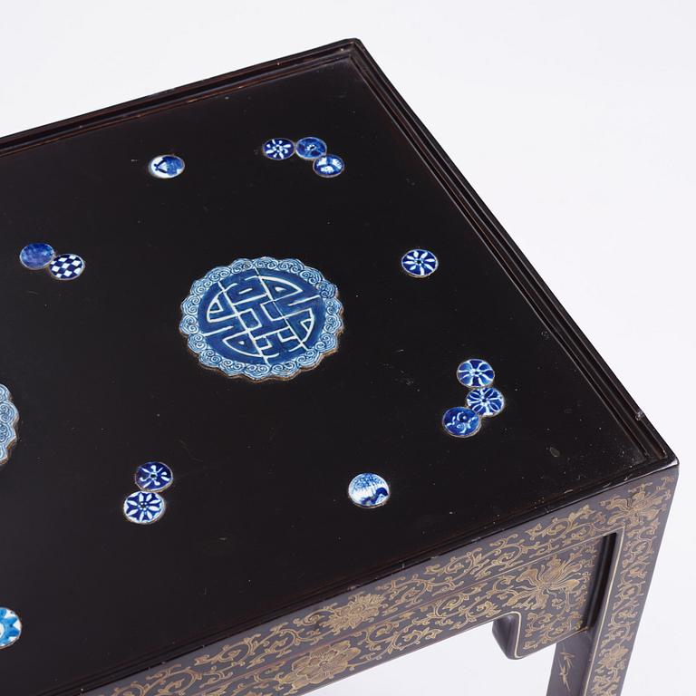 A Chinese black lacquered table with porcelain placques, presumably first half of the 20th century.