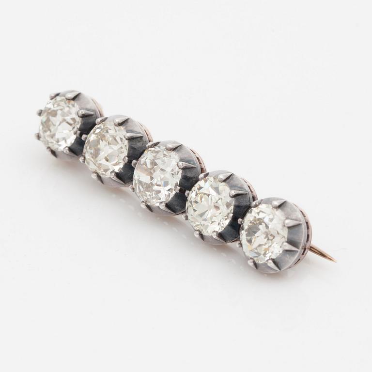 An old-cut diamond brooch set with five diamonds of varying colour. Total carat weight of diamonds circa 8.00cts.