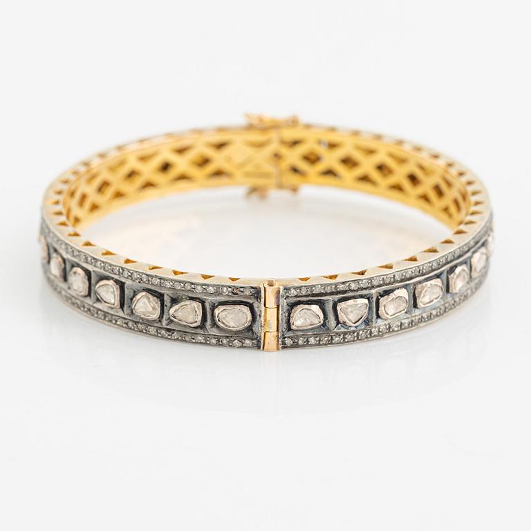 A faceted diamond bangle.