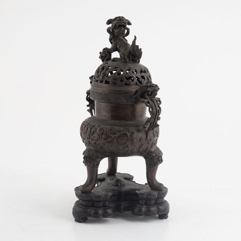 A tripod bronze censer with cover, Qing dynasty, 19th century.