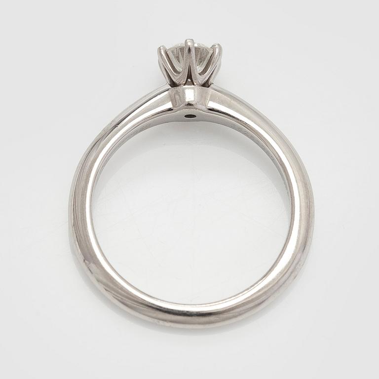 Tiffany & Co, a platinum solitaire ring with a brilliant-cut diamond.