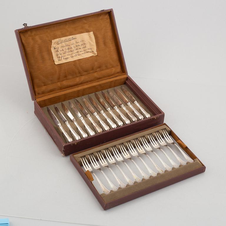 A set of 24 silver fruit knives and forks by Hanna Persson, Kristianstad, Sweden, 1923.